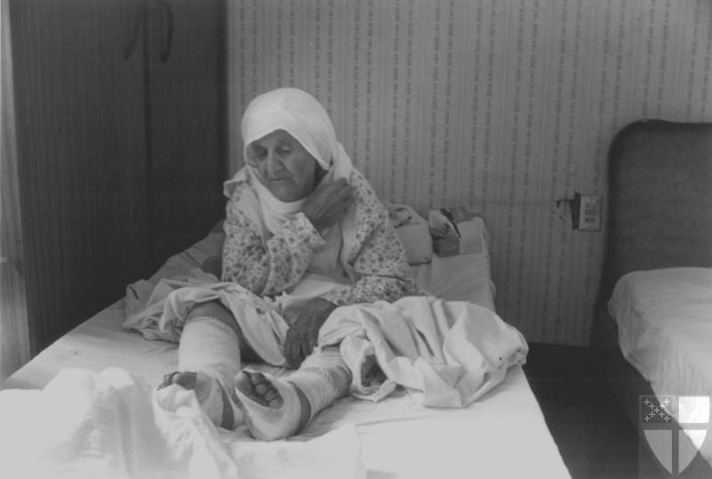 [An elderly woman rests in...]